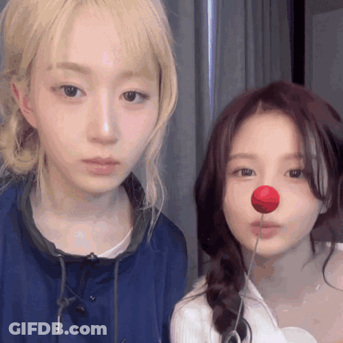 Two Girls Standing One With Red Nose GIF