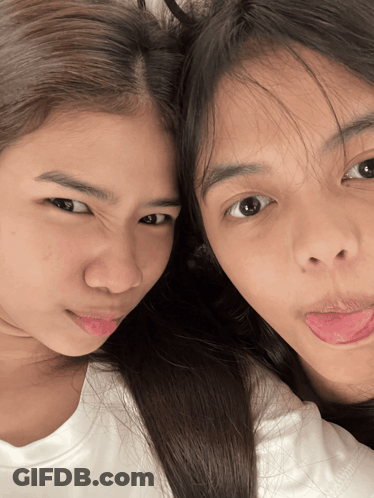 Two Girls Sticking Their Tongues Out And Making Faces GIF