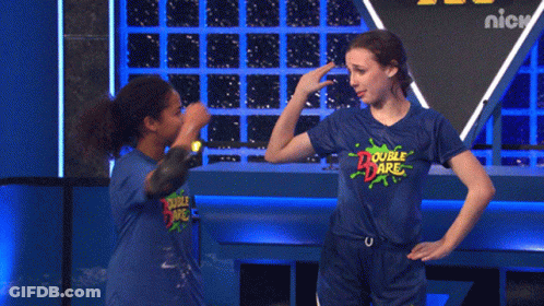 Two Girls Wearing Blue Double Dare Shirts Are Giving Each Other A High Five GIF