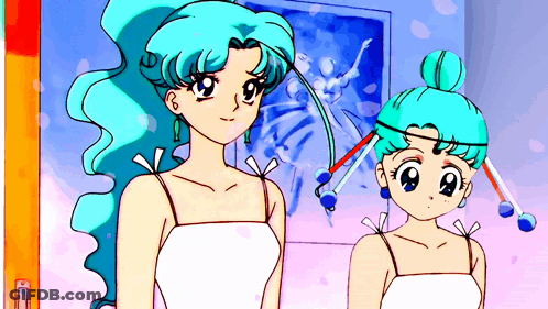 Two Girls With Blue Hair Are Standing In Front Of A Picture GIF