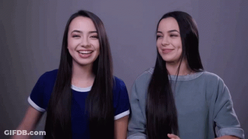 Two Girls With Long Hair Smiling GIF