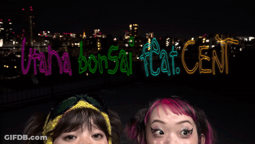 Two Girls With Sign Utah Bonsai Flat Cent GIF