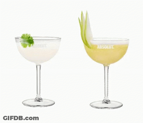 Two Glasses Of Absolut Vodka Are Sitting Next To Each Other On A White Background GIF