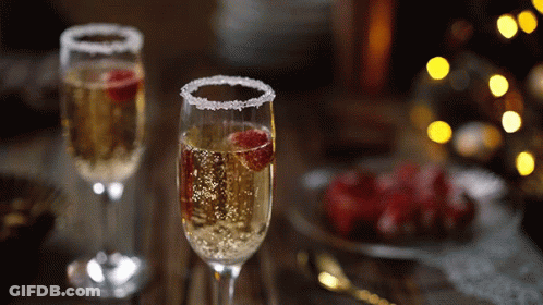 Two Glasses Of Champagne With Raspberries GIF