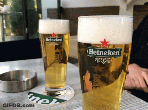 Two Glasses Of Heineken Beer Next To Ashtray GIF