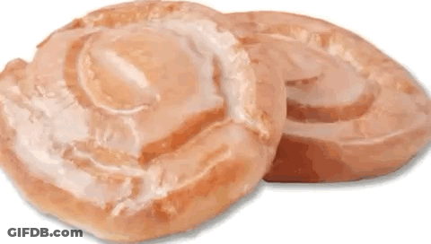 Two Glazed Donuts Are Sitting On Top Of Each Other On A White Background . GIF