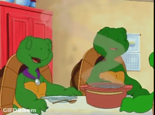 Two Green Turtles Sitting At Table With Soup GIF