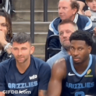 Two Grizzlies Basketball Players Are Sitting In The Stands GIF