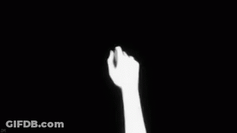 Two Hands Holding Each Other In The Dark GIF