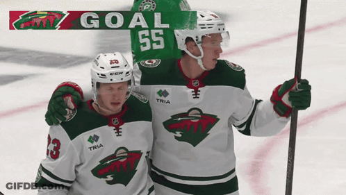 Two Hockey Players Are Celebrating A Goal With The Number 55 On The Back Of Their Jersey GIF