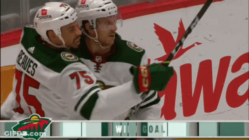Two Hockey Players Are Celebrating A Win With Toyota In The Background GIF