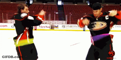 Two Hockey Players Are Dancing On The Ice And One Has The Letter C On Their Jersey GIF