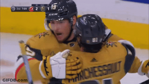 Two Hockey Players Are Hugging Each Other And One Has A Jersey That Says Manchester GIF