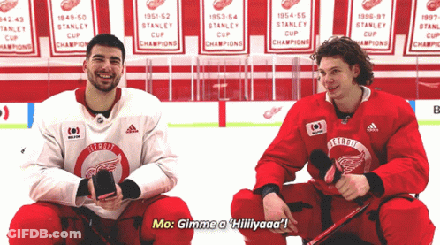 Two Hockey Players Are Sitting On The Ice And One Of Them Is Saying Mo Gimme A Hillyaaa GIF