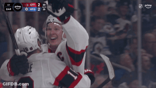Two Hockey Players Celebrating 2-2 Goal GIF