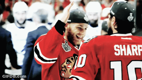 Two Hockey Players High Five Each Other With One Wearing The Number 10 And The Other Wearing The Number 16 GIF