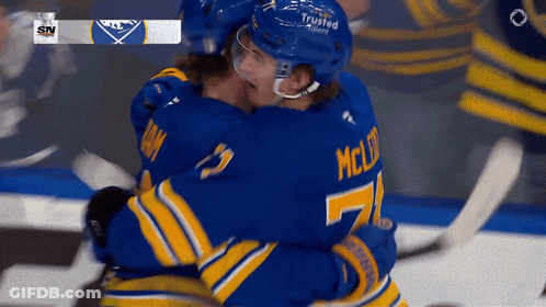 Two Hockey Players Hugging Number 7 Jersey GIF