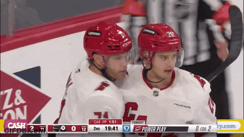 Two Hockey Players Hugging Scoreboard Cash GIF