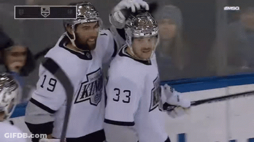 Two Hockey Players In White Jerseys Number 33 GIF