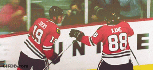 Two Hockey Players One Of Whom Has The Number 88 On His Back GIF