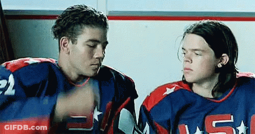 Two Hockey Players Sitting In Locker Room GIF