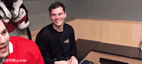 Two Hockey Players Smiling In Locker Room GIF