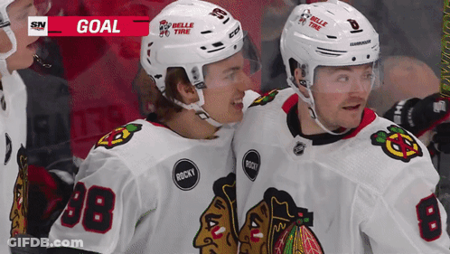 Two Hockey Players Wearing Belle Tire Helmets GIF