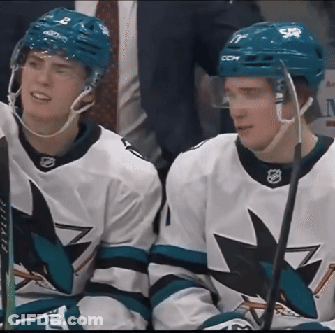 Two Hockey Players Wearing Ccm Helmets Sit On The Bench GIF