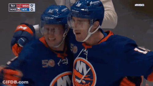 Two Ice Hockey Players Hugging In Front Of Scoreboard 1St WSH 0 NY 1 GIF