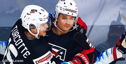 Two Ice Hockey Players One Of Whom Has The Number 21 On His Jersey GIF