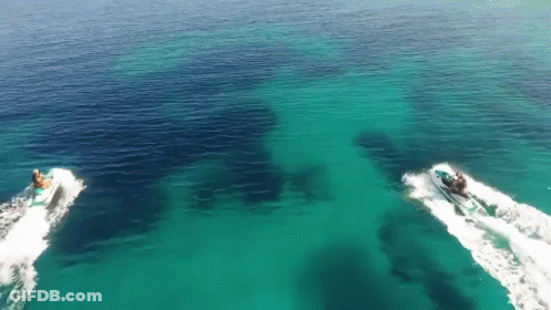 Two Jet Skis Are Floating In The Ocean GIF
