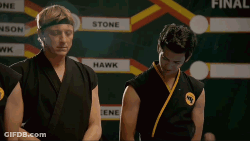 Two Karate Fighters In Front Of Scoreboard Saying Hawk GIF