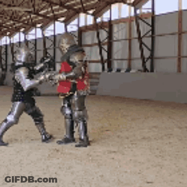 Two Knights In Armor Are Standing In A Building GIF