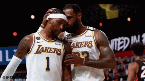 Two Lakers Basketball Players Are Hugging Each Other During A Game GIF