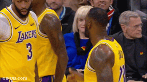 Two Lakers Basketball Players Are Talking To Each Other During A Game GIF