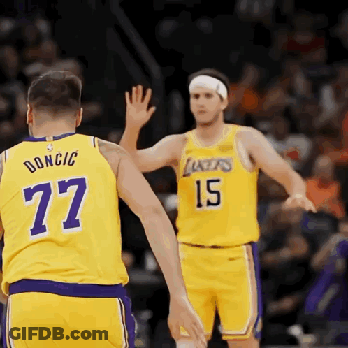 Two Lakers Basketball Players High Five Each Other During A Game GIF