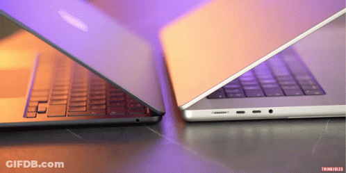 Two Laptops Are Sitting Side By Side And One Has The Word Thinkfiles On The Bottom GIF