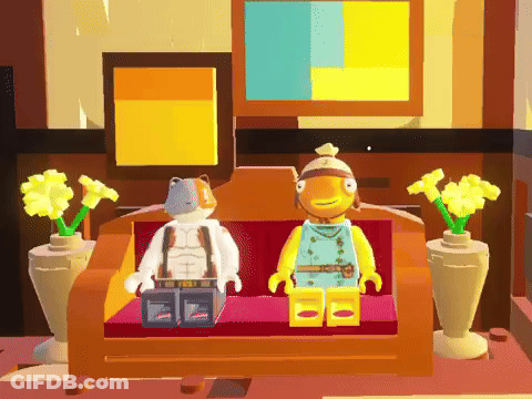 Two Lego Figures Are Sitting On A Couch Next To Each Other GIF
