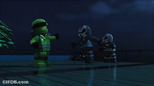 Two Lego Figures Are Standing Next To Each Other In The Dark GIF