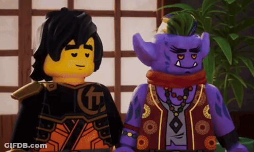Two Lego Figures One In Purple Vest GIF