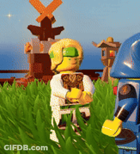 Two Lego Figures Standing Near Windmill GIF
