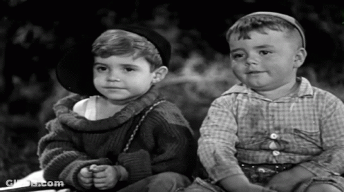 Two Little Boys Sitting Next To Each Other One Wearing Hat GIF