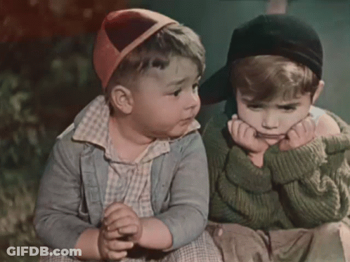 Two Little Boys Sitting With Hands On Faces GIF