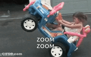 Two Little Girls Are Riding In A Toy Car With The Words Zoom Zoom On The Bottom . GIF