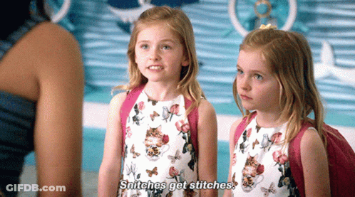 Two Little Girls Are Standing Next To Each Other And One Says Snitches Get Stitches GIF