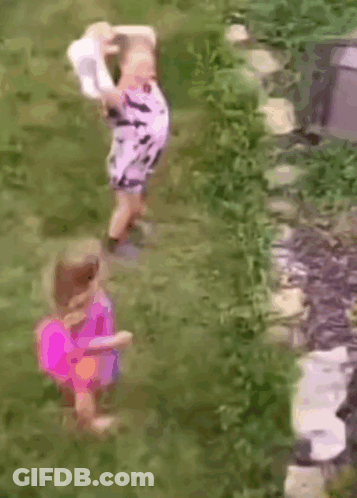 Two Little Girls In Grass One Holding Hat GIF