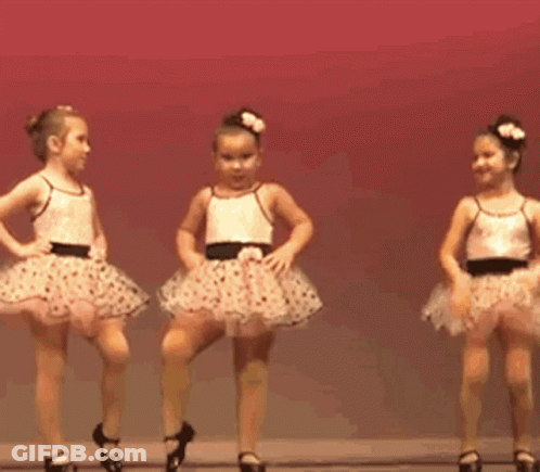 Two Little Girls In Tutus Are Dancing On A Stage In Front Of A Red Background . GIF