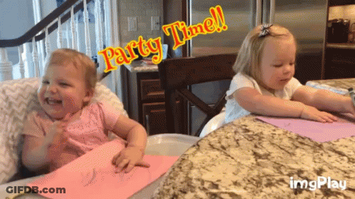 Two Little Girls Sitting At Table Saying Party Time GIF