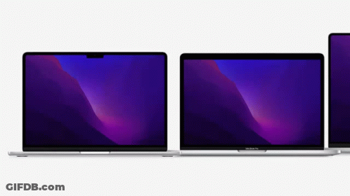Two Macbook Pro Laptops Are Sitting Next To Each Other On A White Surface . GIF