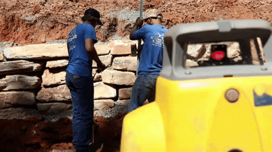 Two Man In Blue Shirts Surveying Around GIF